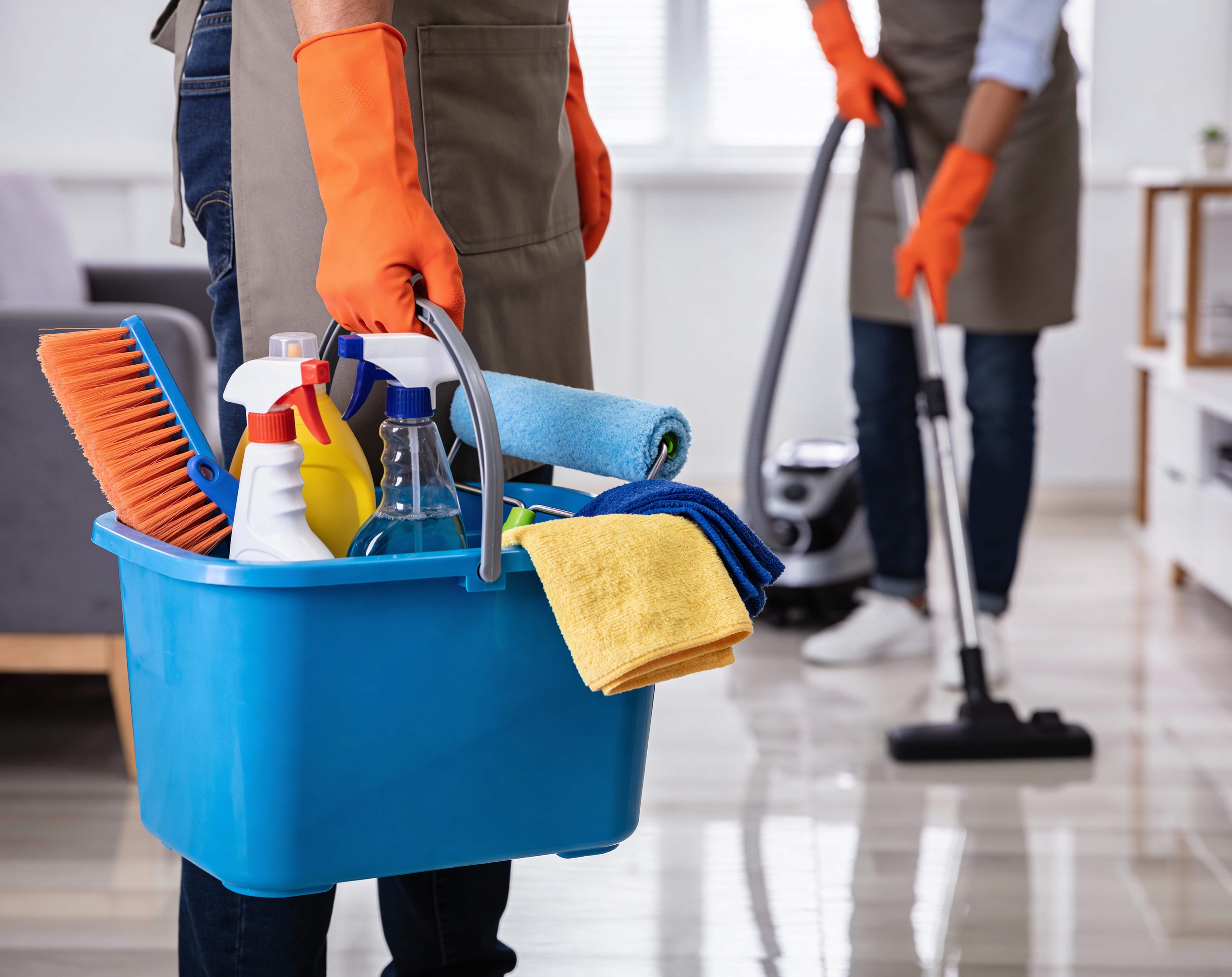 A cleaner vacuuming a tidy living room